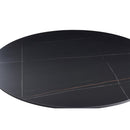Tavolo rotondo Dot con piano in ceramica effetto marmo nero opaco con particolari oro e gamba nera